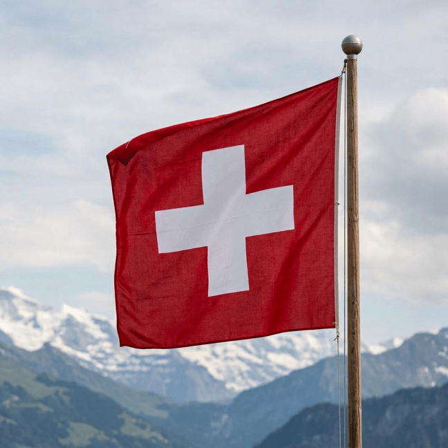 Swiss flag on a pole with mountains; text: PUBLIC DOMAIN – CC0, FREELY USABLE FOR COMMERCIAL PURPOSES, STOCK PHOTO FOR BLOGS